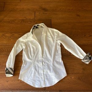 Burberry women’s white button down with plaid collar and cuffs.